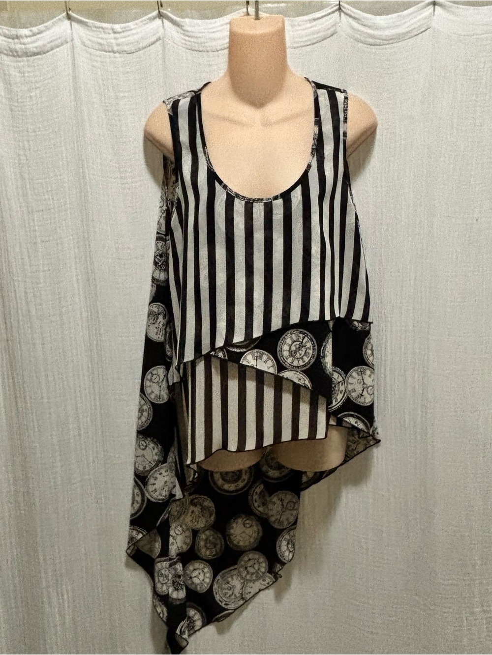 Pyramid Collection top with a hi-low asymmetrical hem and a unique clock pattern